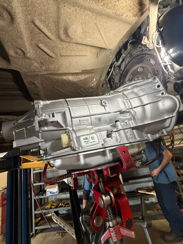 Transmission beneath a raised vehicle