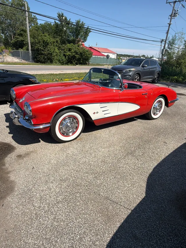 Red and white classic convertible outside the shop